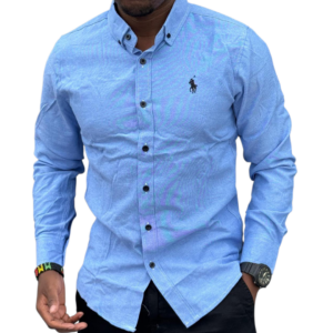 Men wearing a blue slim fit cotton polo shirt with button-down front and long sleeves, styled with dark trousers on a clean white background.