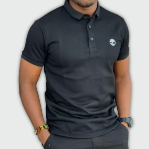 Man wearing a cotton classic black polo t-shirt with short sleeves and slim fit, featuring a classic collar and button placket for smart-casual style