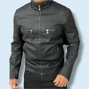 Front view of a man wearing a slim‑fit black leather jacket with quilted shoulders, zip front, and zip pockets, styled with black pants.