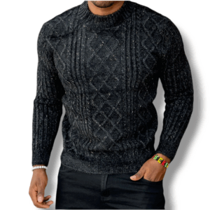 A gentleman is shown from the waist up wearing a dark-coloured cable-knit sweater with detailed diamond patterns, standing against an indistinct background.