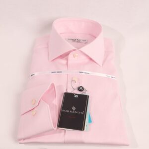 Folded pink Sorrento non-iron slim fit dress shirt with cutaway collar and wrinkle-free label, neatly displayed on a white background with brand tag visible.