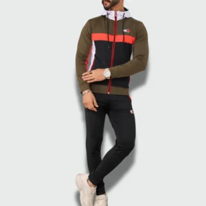 Man wearing a men’s Tommy Hilfiger slim fit tracksuits with zip-up jacket and tapered jogger pants featuring a sporty color-block design