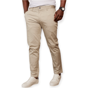 a man standing at akimbo in beige men's khaki trouser pants and white sneakers.