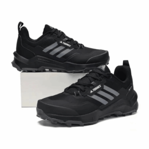a pair of black Adidas Terrex men’s trail sneakers on the white background