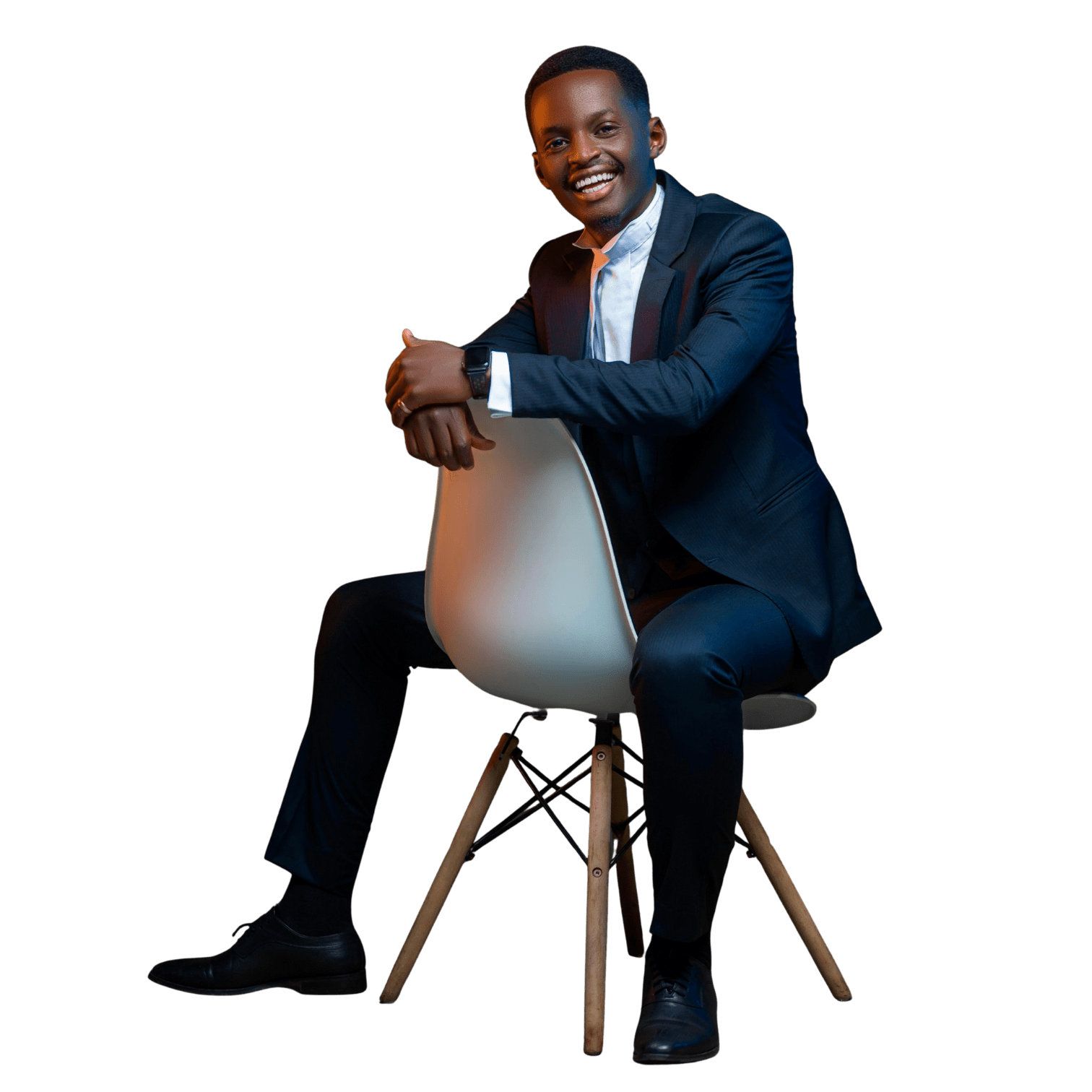 a man in a dark blue suit sitting on chair.