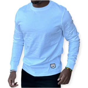 Man wearing a long sleeved white cotton t-shirt with a slim fit, styled casually with black jeans for everyday wear