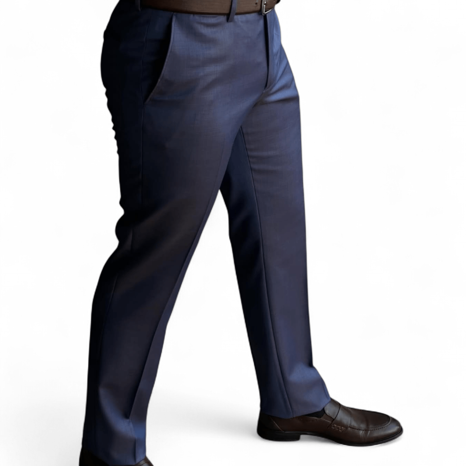 Man wearing navy blue slim fit formal pants paired with brown leather dress shoes on a clean white background.