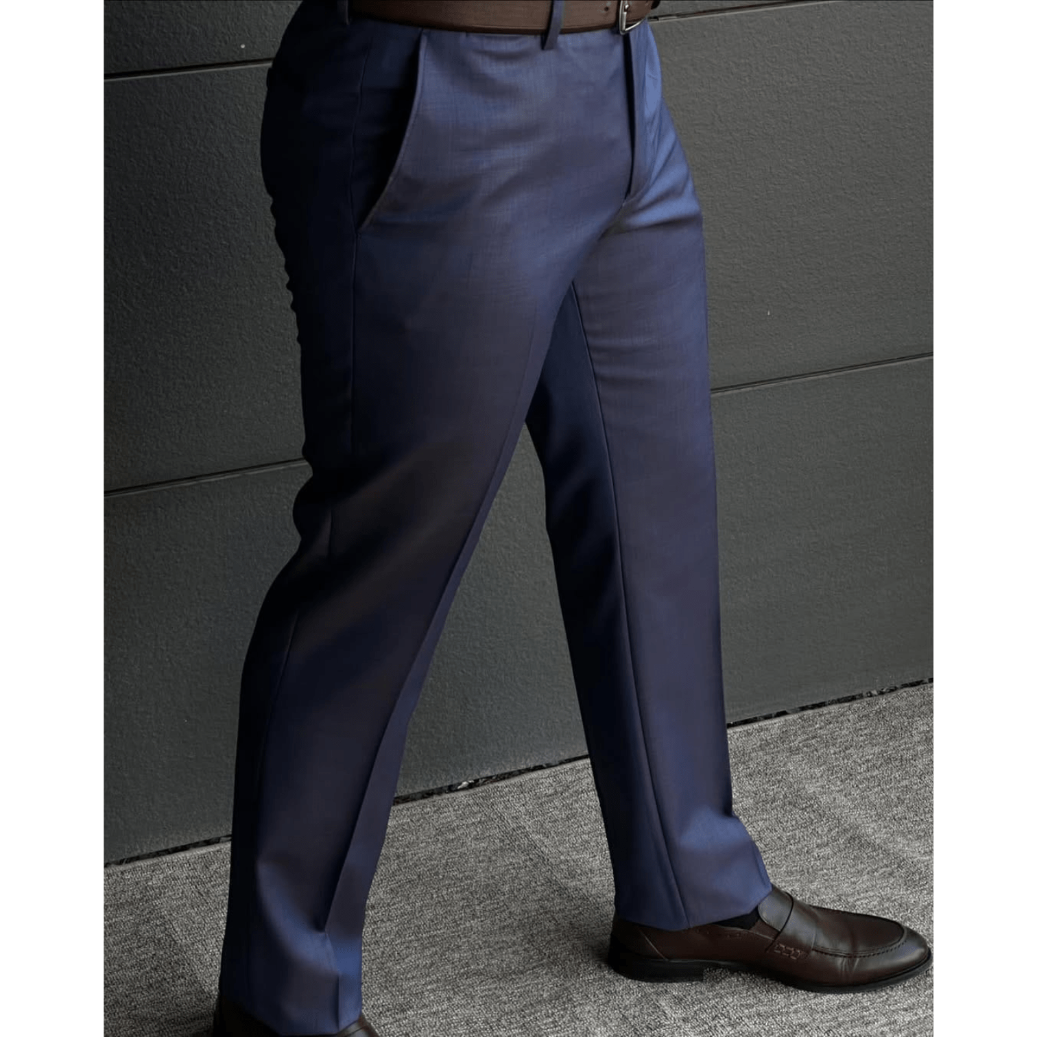 Man wearing navy blue slim fit formal pants paired with brown leather dress shoes, shown against a clean white background.