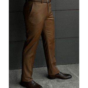 Man wearing brown wool formal trousers paired with brown leather dress shoes, photographed in a modern indoor setting.