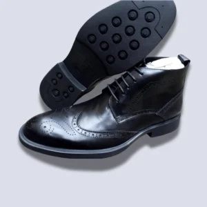 Men’s black leather ankle boots with lace-up design and rubber sole, formal and office-ready boots with classic brogue detailing.