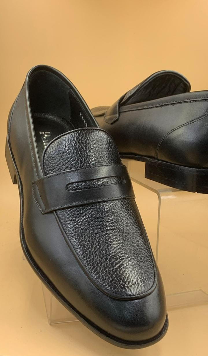 Men’s black Pampa leather loafers with textured leather upper and classic leather sole displayed on stand.