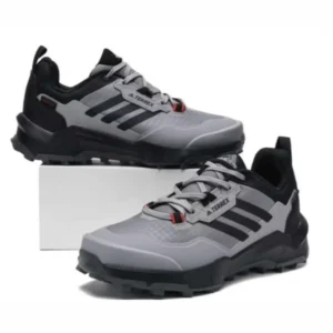 Grey Adidas Terrex sneakers with rugged sole and lace-up design, suitable for outdoor wear, hiking, and everyday street style.