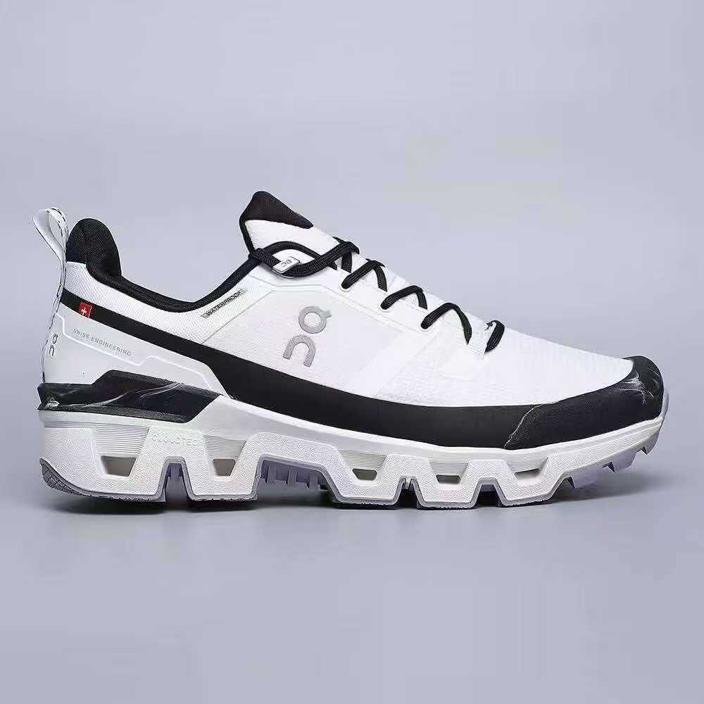 White and black On Running men’s Cloudwander Waterproof sneakers with cushioned sole, lightweight design, and lace-up closure for running and training.